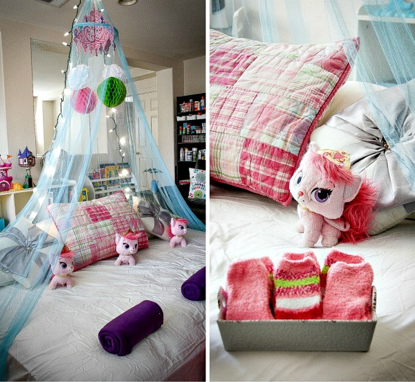 a blue pink and purple sleepover bed with a canopy, string lights, and stuffed toys