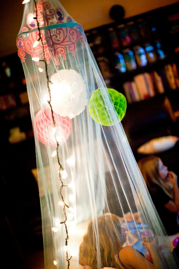 little girls inside a lighted canopy during a sleepover