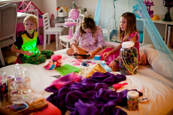girls doing craft projects on a sleepover mattress