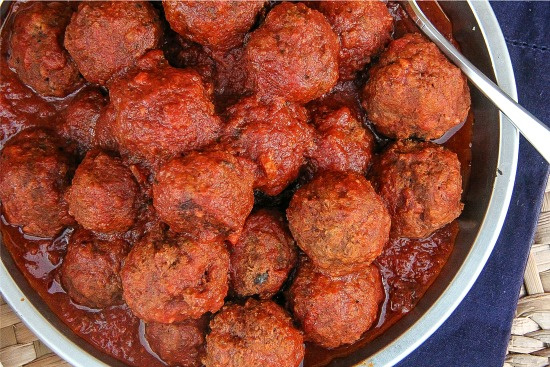 meatballs with a red sauce in a bowl for serving