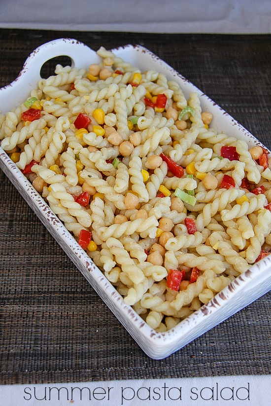 a pasta salad with garbanzo beans, corn, and bell peppers