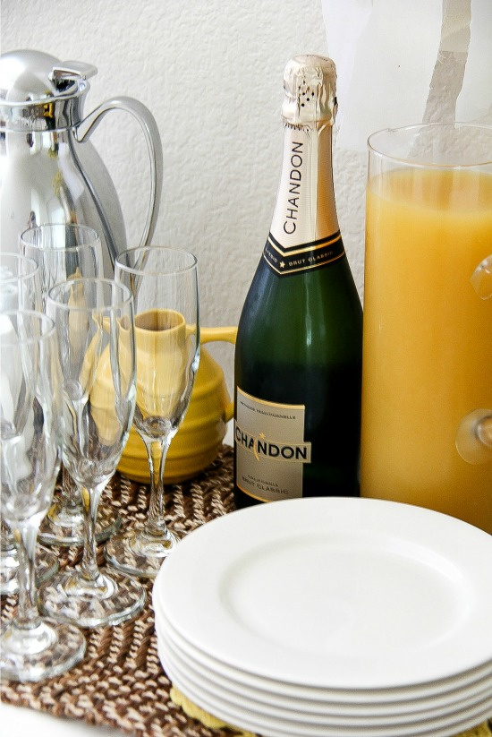 a bottle of Chandon sparkling wine with a pitcher of orange juice to make mimosas