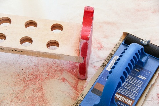 a melissa and doug peg toy being repurposed into a test tube stand