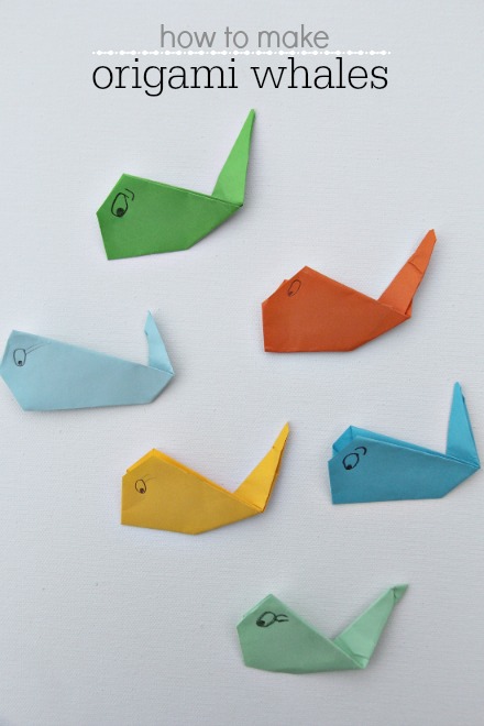 origami whales in different colors made by kids