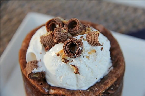 chocolate curls on top of whipped cream on a cheesecake