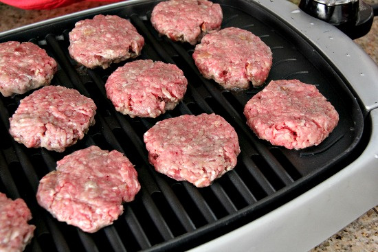 burgers cooking on an indoor grill