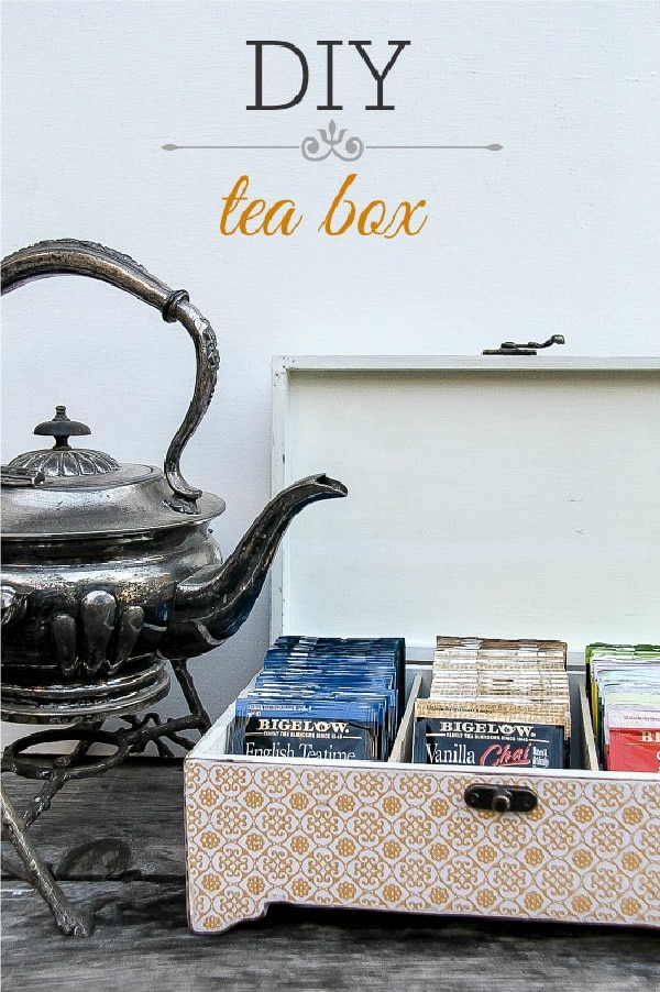 an orange and white wood tea box with an antique silver tea pot