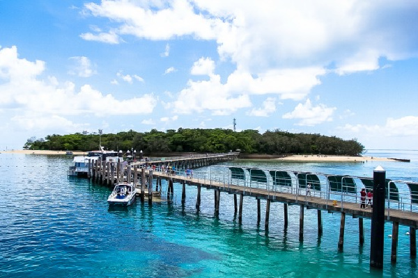 boats at the jetty at green island in australia