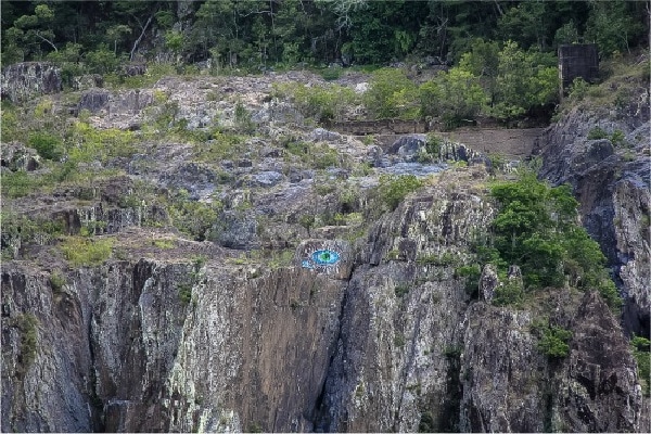 a blue eye painted on the side of a mountain in queensland