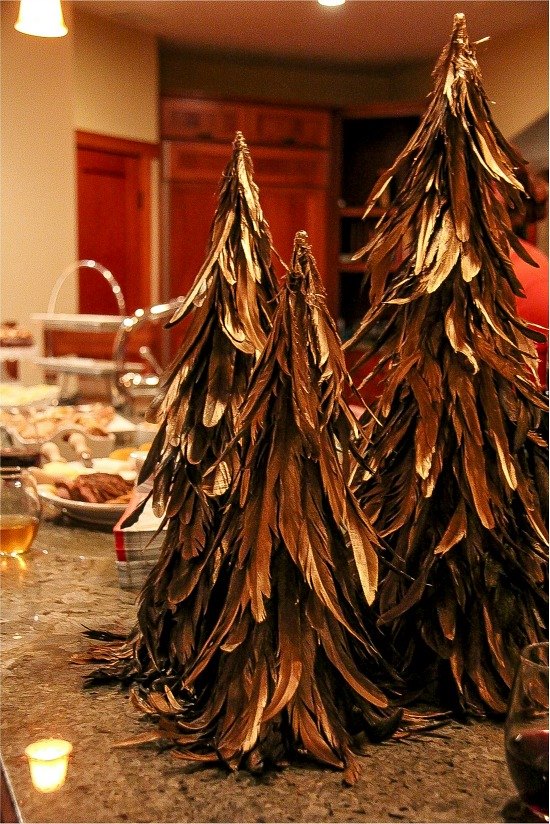 feather christmas trees and party food on a counter