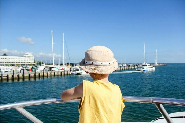 boy on the deck of the reef king catamaran at the great barrier reef