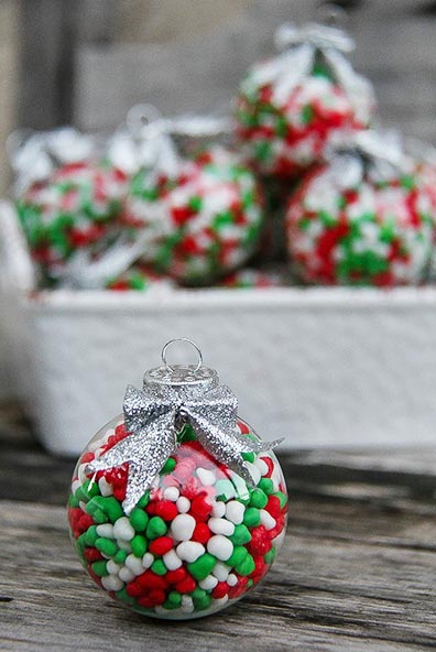 clear holiday ornaments filled with green, red, and white candy