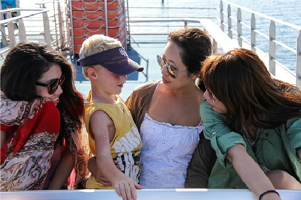 boy and female tourists on a catamaran