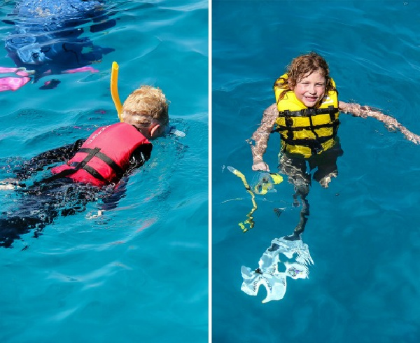 kids snorkeling in the blue water at the great barrier reef