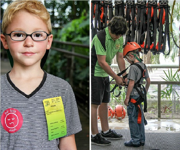 a boy getting a harness to do the ZOOm obstacle course in Cairns