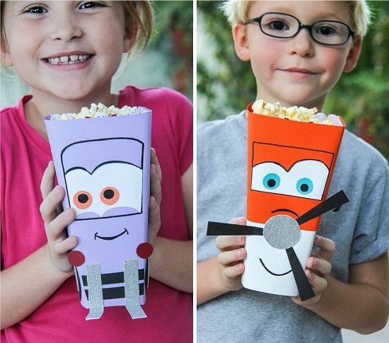 Kids holding handmade Disney Planes Dusty Crophopper and Dottie popcorn tubs for a movie night