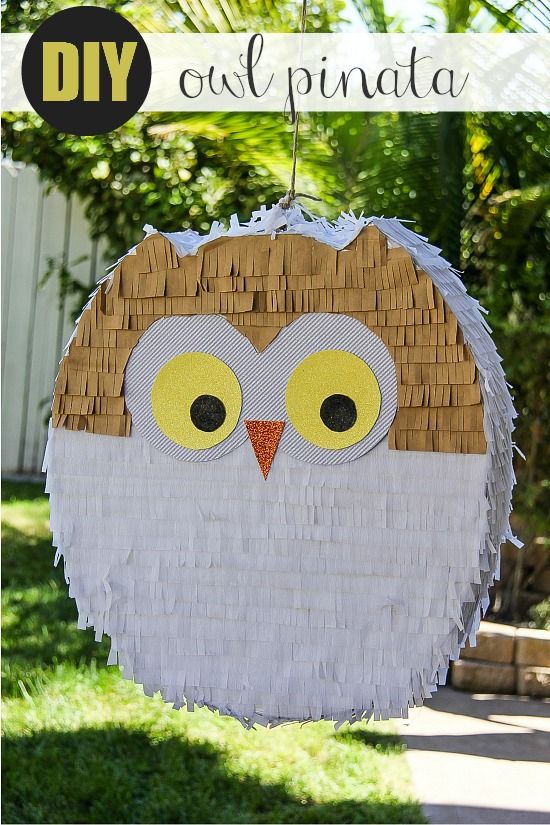 a homemade white and gold owl pinata