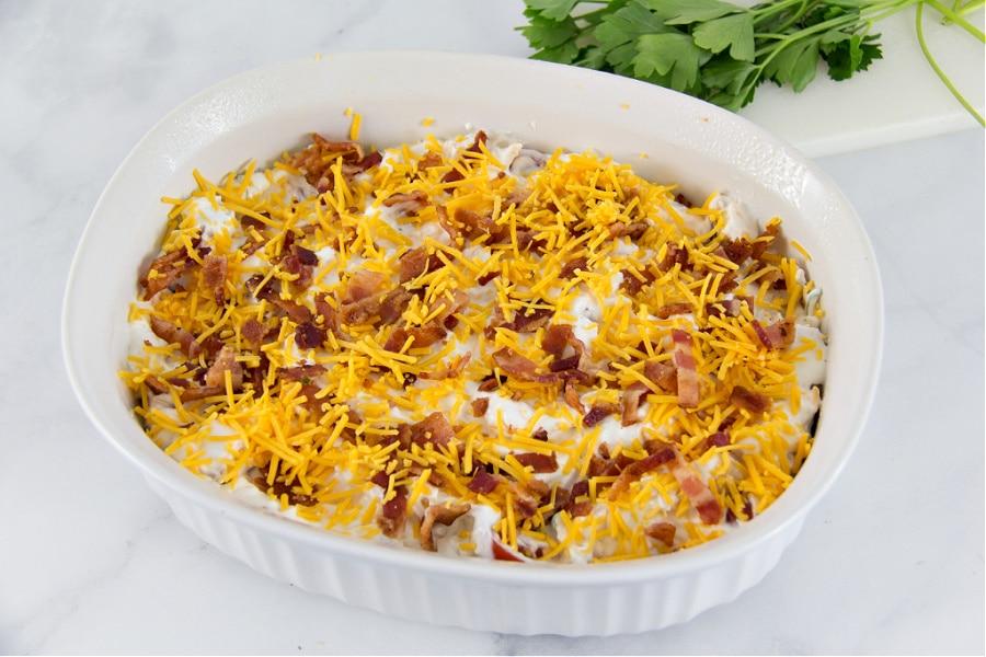 Kentucky Hot Brown dip in a white casserole dish ready to go into the oven.