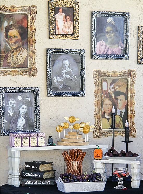 Harry Potter party table with food, shifting artwork on the walls, and Halloween decor