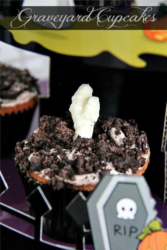 Graveyard cupcakes for Halloween with white chocolate bones and crushed Oreo's.