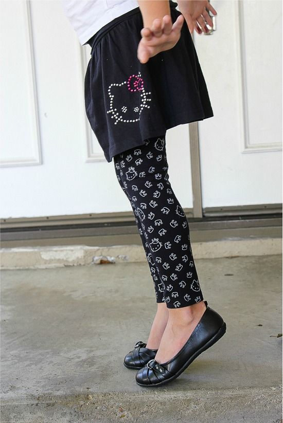 girl wearing a black Hello Kitty skirt with black and white Hello Kitty leggings