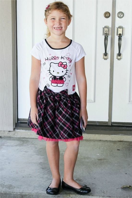 girl wearing a Hello Kitty dress in black, pink, and white.