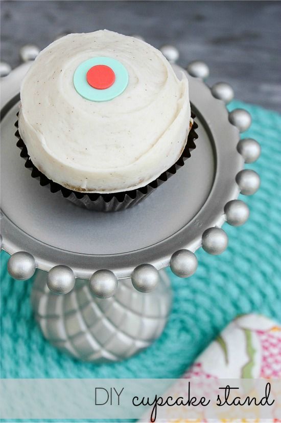 A Sprinkles cupcake on top of a silver metallic cupcake stand