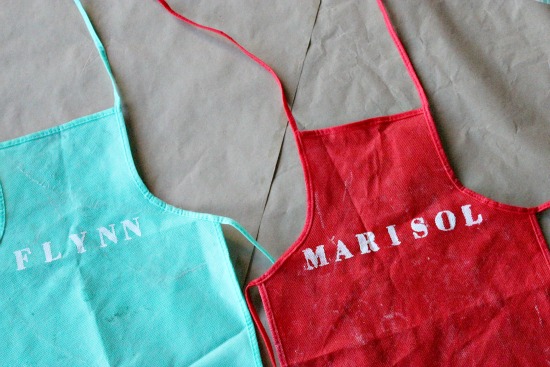 names stenciled onto plain kids aprons for cookie decorating