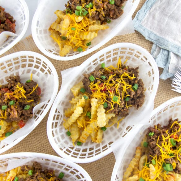 loaded sloppy joe fries in white baskets lined with wax paper