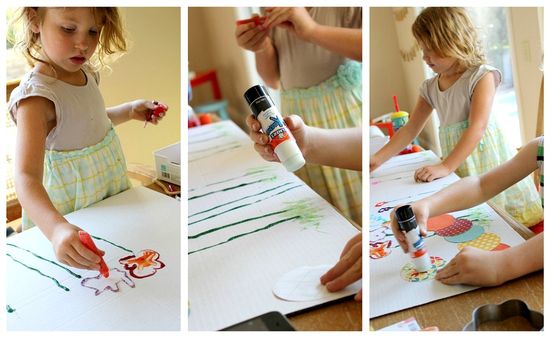 kids drawing flowers and making a caterpillar on a project board