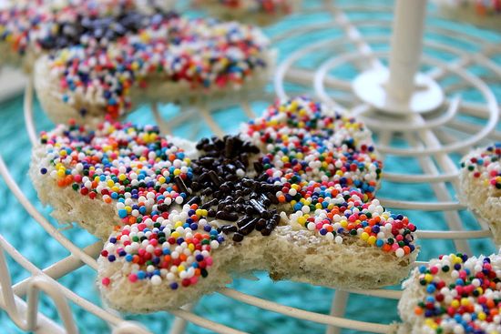 Butterfly shaped bread treats made with a cookie cutter and covered in rainbow sprinkles.