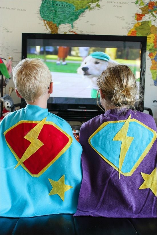 A boy and girl wearing handmade fleece no-sew super hero capes