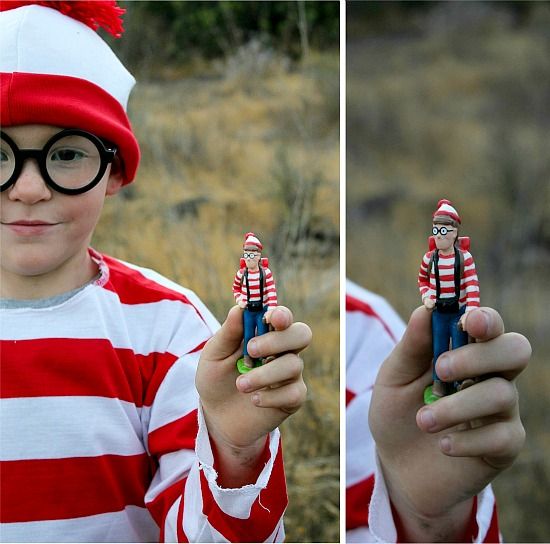 A boy wearing a Where's Waldo costume and holding a Where's Waldo toy for geocaching.