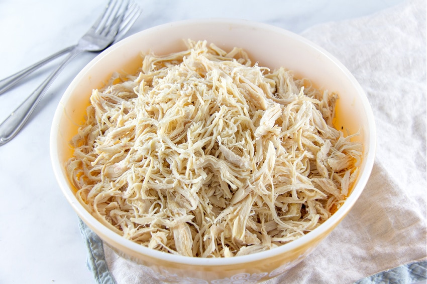 shredded chicken in a yellow bowl