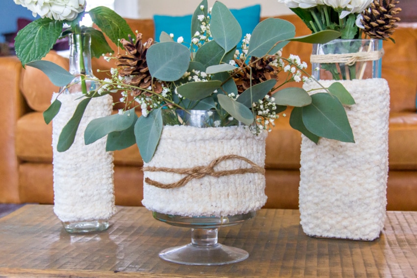 knit winter vase cozies for winter floral arrangements.