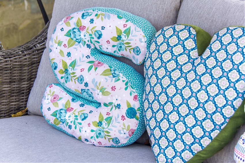 handmade letter and heart-shaped pillows made with floral fabric