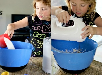 a girl mixing batter for cookies in a large mixing bowl