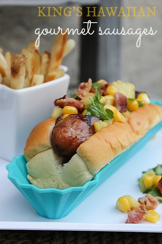 King's Hawaiian hot dog bun in a blue bowl with chicken sausage, corn, bacon, and pineapple.