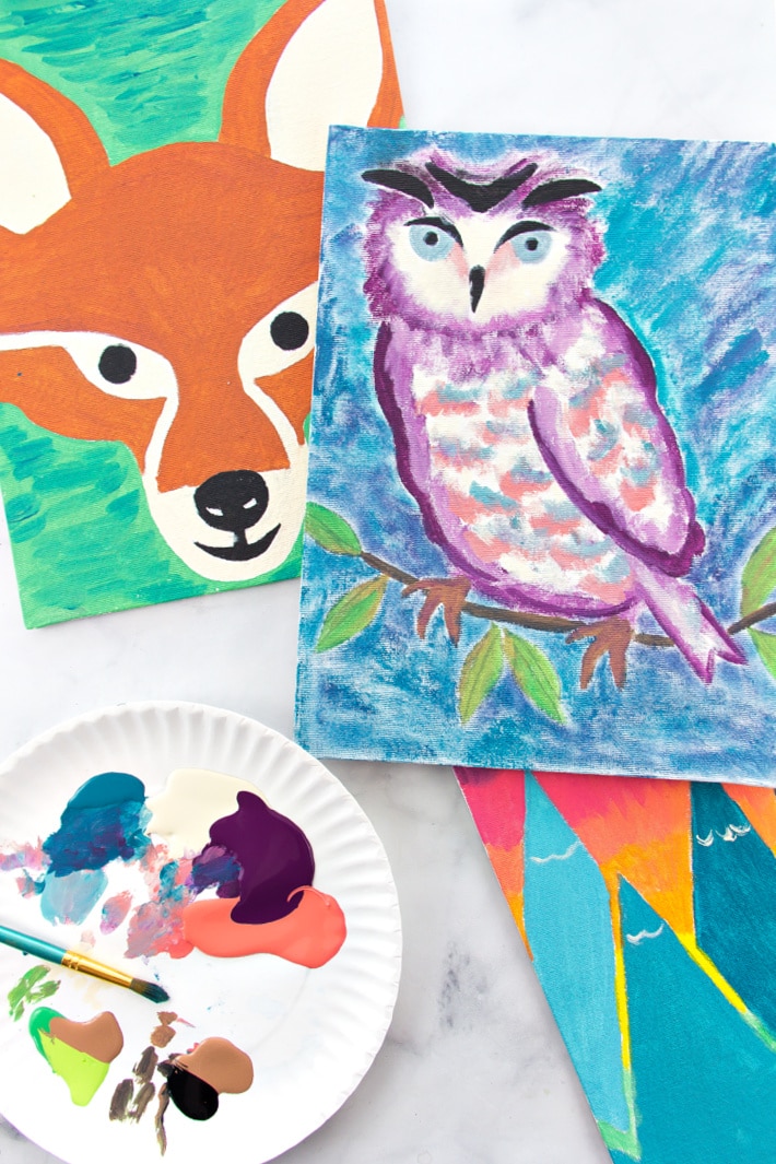 Nature art for kids. Paintings of a fox, owl, and mountains that used stencils. 