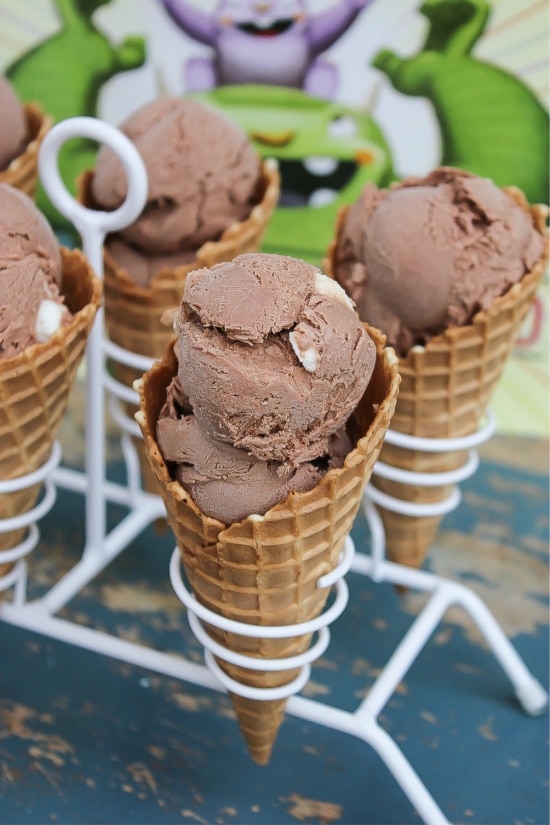 homemade rocky road ice cream in cones in a white cone holder