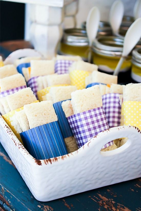 Sandwiches wrapped in paper to match a party color theme.