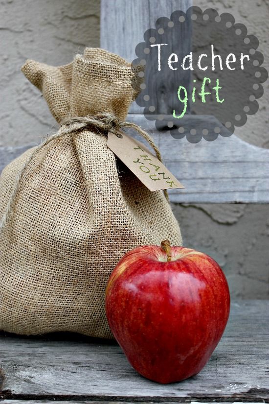 A burlap bag filled with apples with a card attached that reads we got the pick of the bunch.