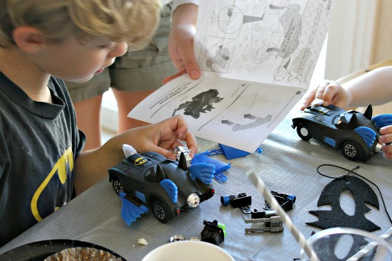 Kids making an Xtreme Customz Batmobile during a Batman party.