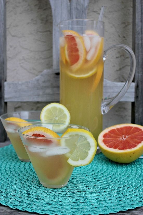 A Moscato cocktail in a jug with glasses of the cocktail filled. 