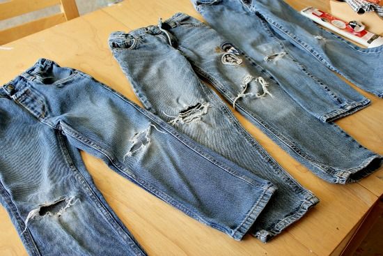 Boys jeans with holes that need to be patched.