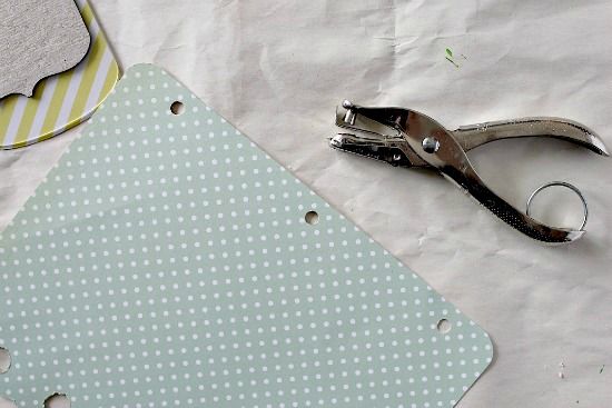 Tips for making a DIY scrapbook album including hole punching pages and binding them.