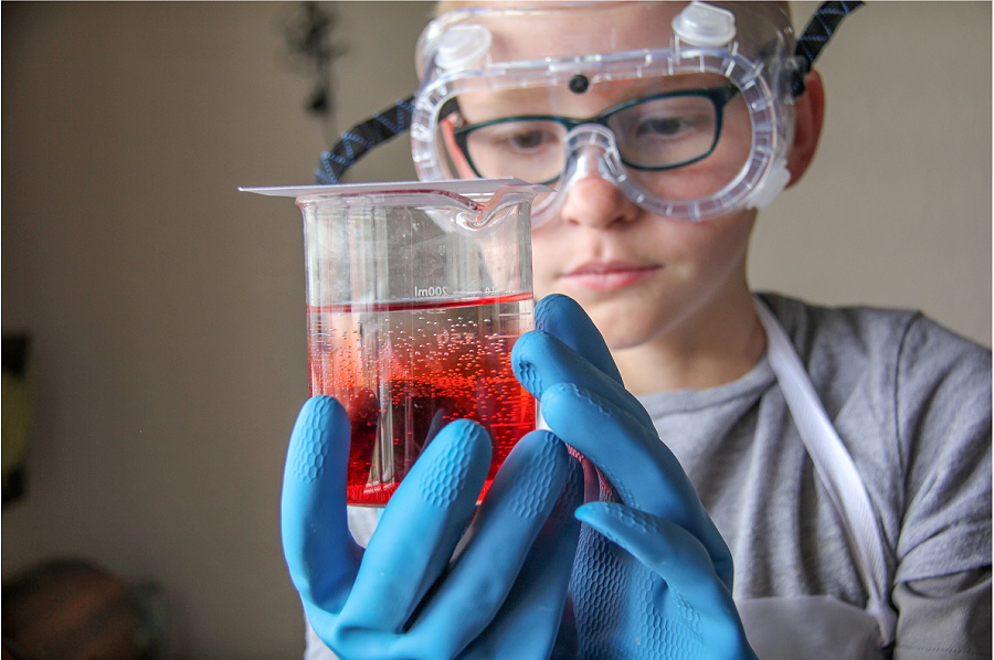 a boy using a home science kit