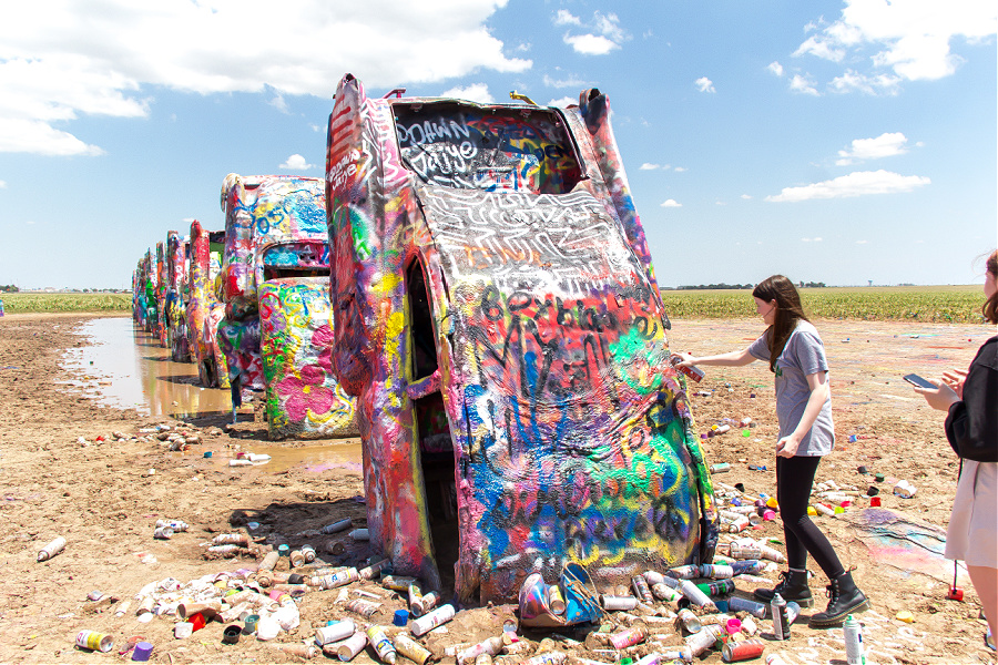 spray painting the cadillacs at the Cadillac Ranch in Amarillo Texas