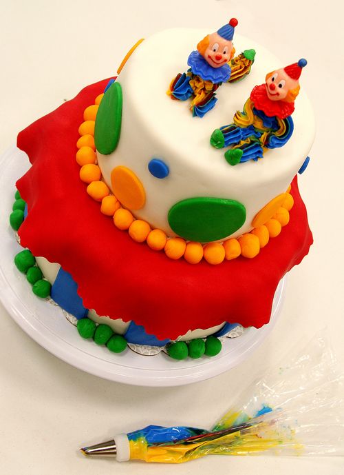 a homemade layered clown cake in bright colors.