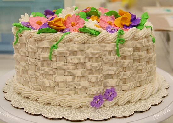 A handmade cake that looks like a basket full of flowers.